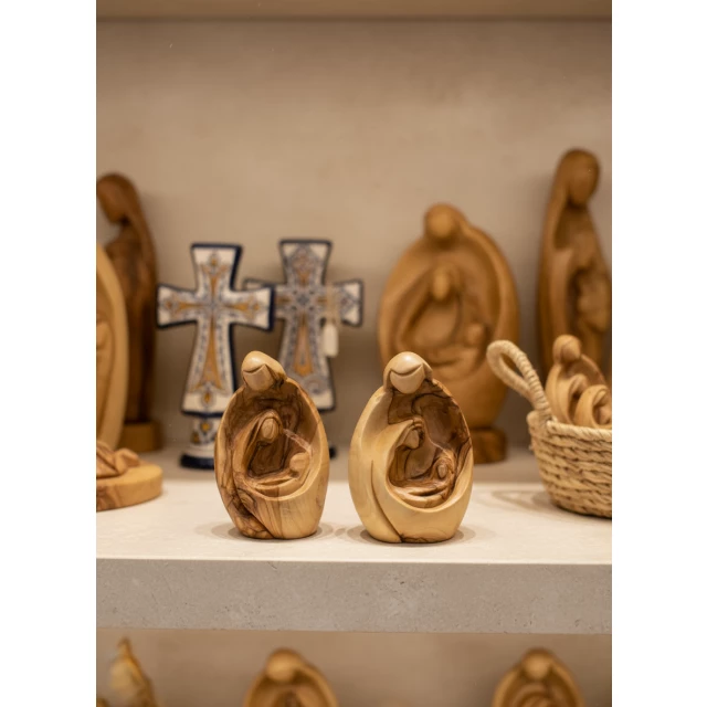 Close-up detail of Mary baby Jesus figurine showing fine hand-carved bethlehem wood carving
