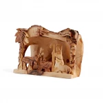 Side view of hand-carved Bethlehem nativity carving showing manger scene detail