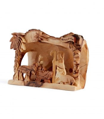 Side view of hand-carved Bethlehem nativity carving showing manger scene detail