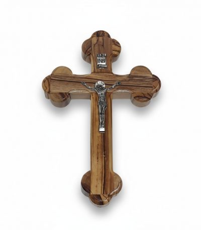 Wooden crucifix for wall with rounded trefoil ends and silver corpus on white background